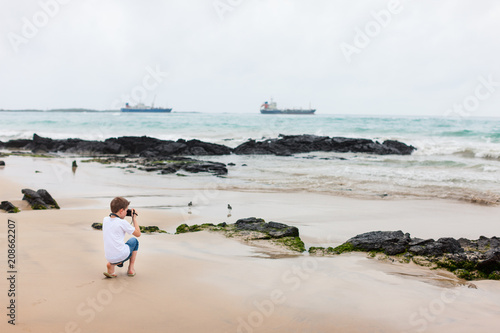 Little boy at rocky coast