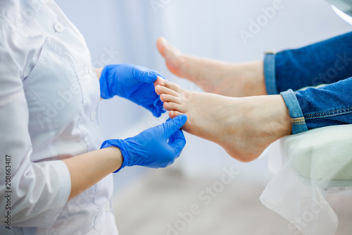 Podiatry doctor examines the foot photo