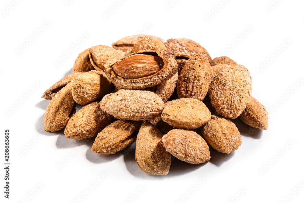 Pile of sweet almond nut with shell and salt isolated on white background. Pile of sweet almond nut with shell and salt isolated on white background.