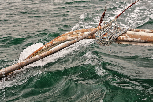 Bamboo outrigger projecting from a Filipino bangka boat-N.Bays Bay-Negros Oriental-Philippines.0529 photo