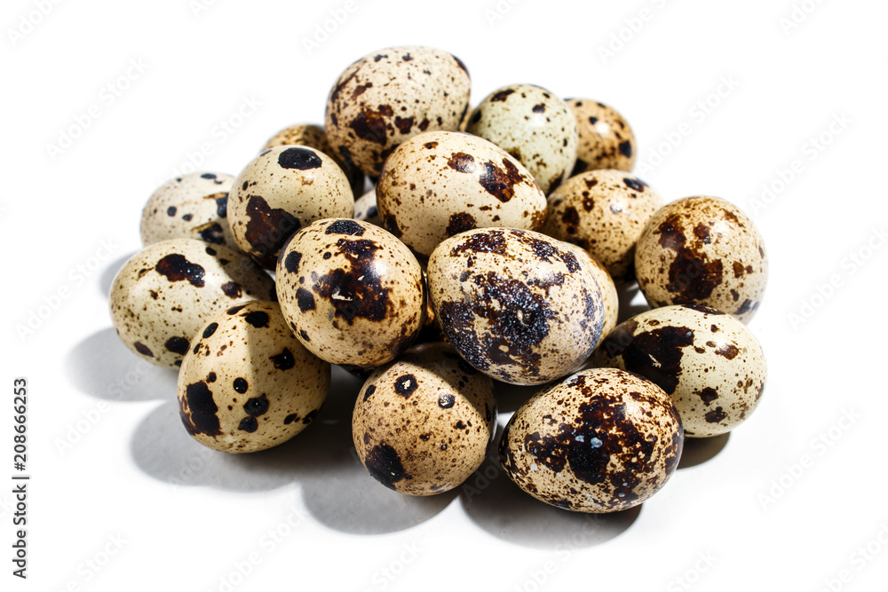 Pile of quail eggs isolated on white background.