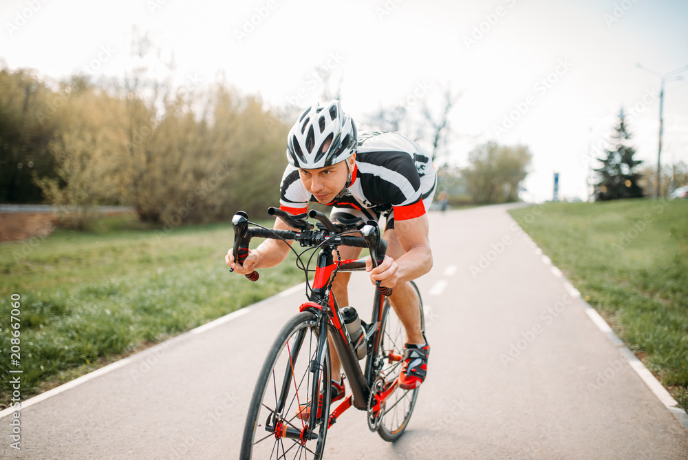 Cyclist in helmet and sportswear, bicycle training Cyclist in helmet and sportswear, bicycle training