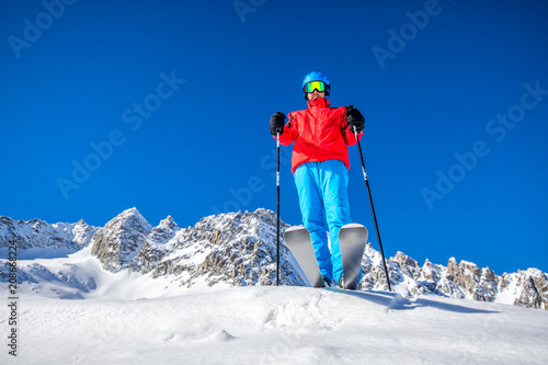 Young happy skier ready for skiing on the top of Alps.