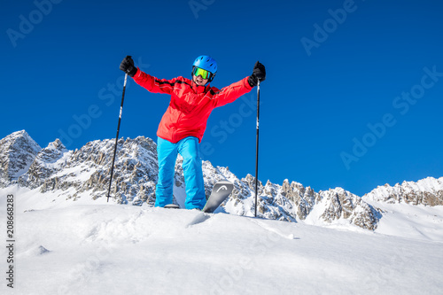 Young happy skier ready for skiing on the top of Alps.