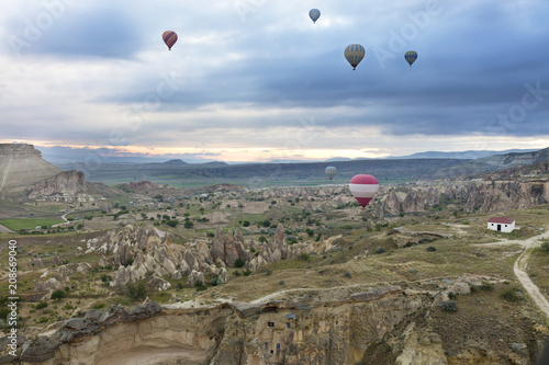 Several balloons fly over the valleys in Cappadocia