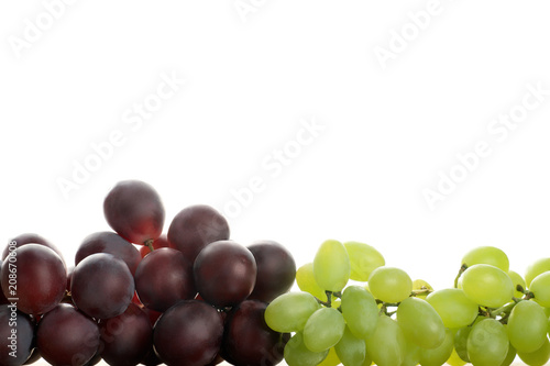 Green and red grapes on white