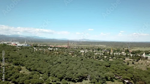 aéreo drone  volando sobre un bosque y al fondo puente  de la autopista  a6  y vehículos circulandoo por la autopista  las rozas de madrid, y al fondo sierra de madrid photo