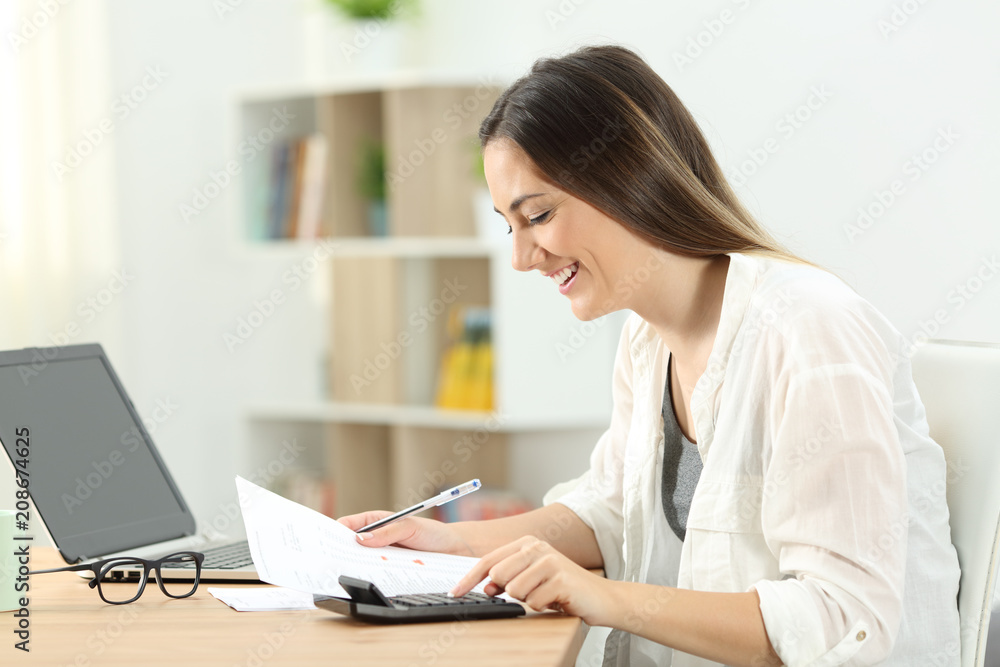 Happy woman doing domestic accounting Happy woman doing domestic accounting