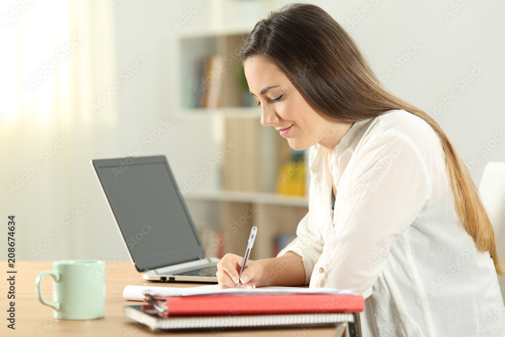 Profile of a student taking notes at home Profile of a student taking notes at home