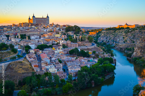 Sunset at lookout of Toledo, Spain. Tajo river around the city and Alcazar and Cathedral at background.