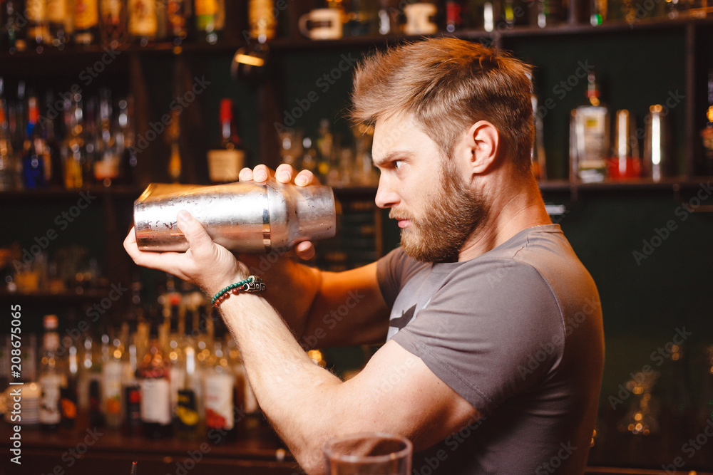 A stern bartender mixes a cocktail in a shaker