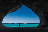 Woman inside a cave at Cala Luna beach