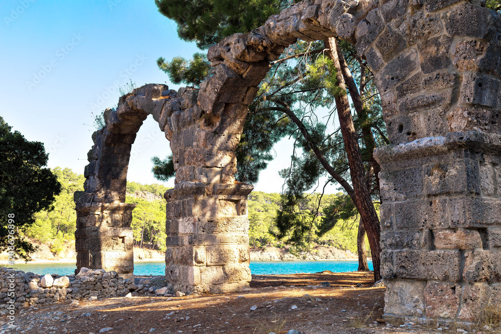  ancient destroyed aqueduct of the city of Phaselis, Turkey, Kemer in sunny summer day