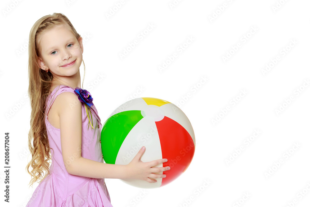 Beautiful little girl with a large multi-colored inflatable ball Beautiful little girl with a large multi-colored inflatable ball