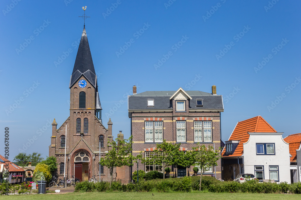 Fototapeta premium Martinus church and old houses in Oudeschild on Texel island, The Netherlands