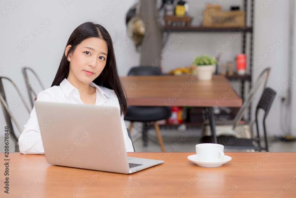 Beautiful asian young woman working online on laptop sitting at coffee shop, professional female freelancer using notebook computer with connect to internet for distance job. Beautiful asian young woman working online on laptop sitting at coffee shop, professional female freelancer using notebook computer with connect to internet for distance job.