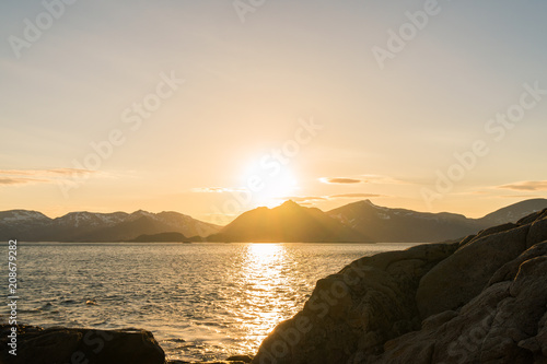 View over the Rorvikstranda beach and Gimsoystraumen fjord near Henningsvaer at Lofoten Islands / Norway at sunset photo