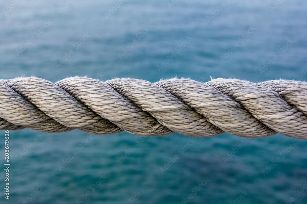 old marine rope on the pebble beach