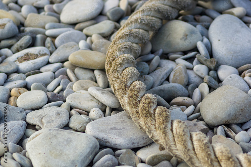 old marine rope on the pebble beach old marine rope on the pebble beach