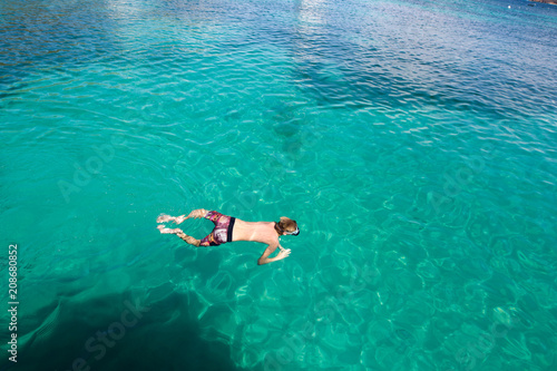 kid snorkeling in a blue lagoon - St-Vincent and the Grenadines