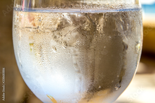 a glass of water and ice with drops