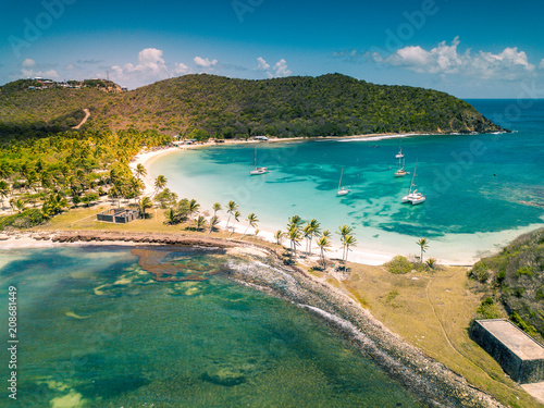 Aerial view of Mayreau beach in St-Vincent and the Grenadines - Tobago Cays. The paradise beach with palm trees and white sand beach photo