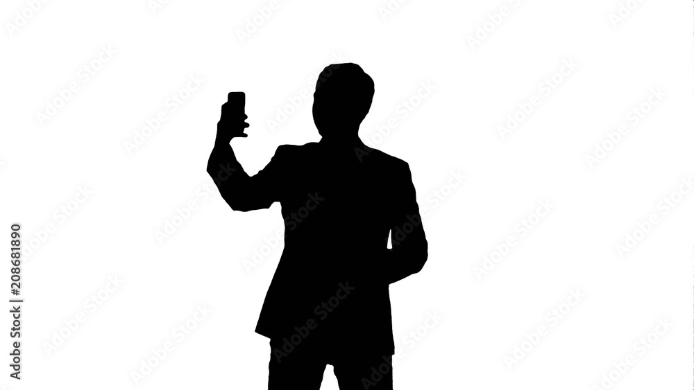 Silhouette Young man taking a selfie photo with his smartphone