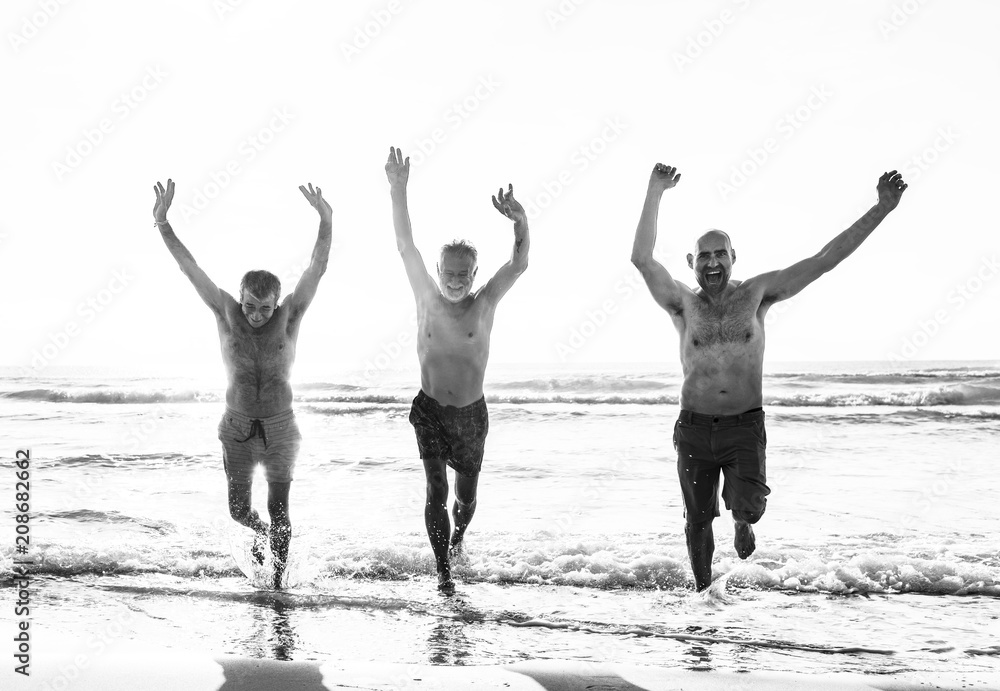 Senior friends enjoying the beach in the summertime Senior friends enjoying the beach in the summertime
