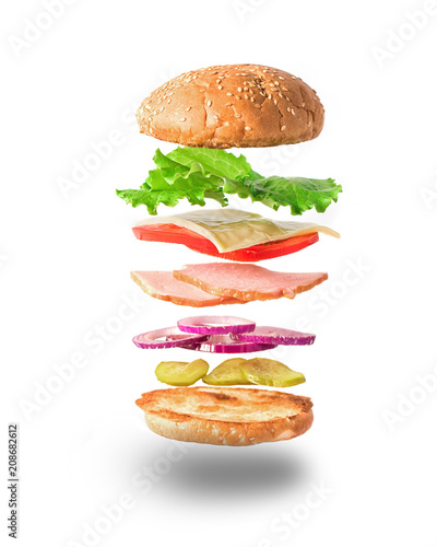 Fresh sandwich with flying ingredients isolated on white background