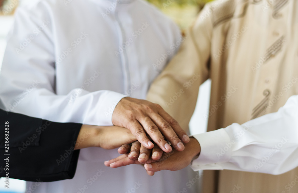Muslim group of friends stacking hands Muslim group of friends stacking hands