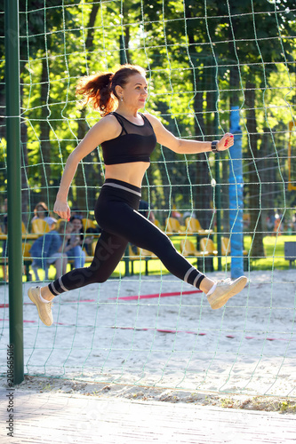cute young sporty girl in jump running at a distance
