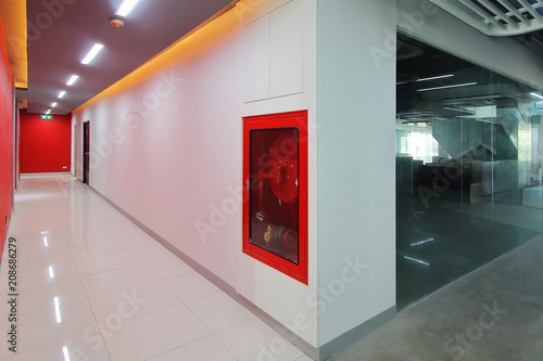 Emergency exit of the building with fire exit sign,fire alarm and Fire extinguisher