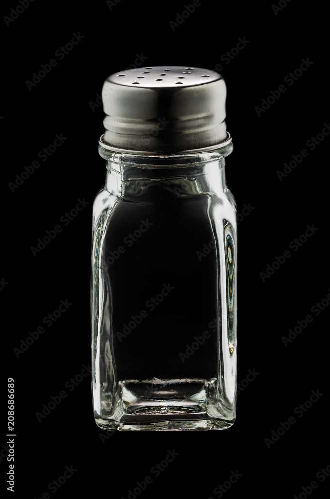 An empty glass shaker of salt isolated on black background An empty glass shaker of salt isolated on black background