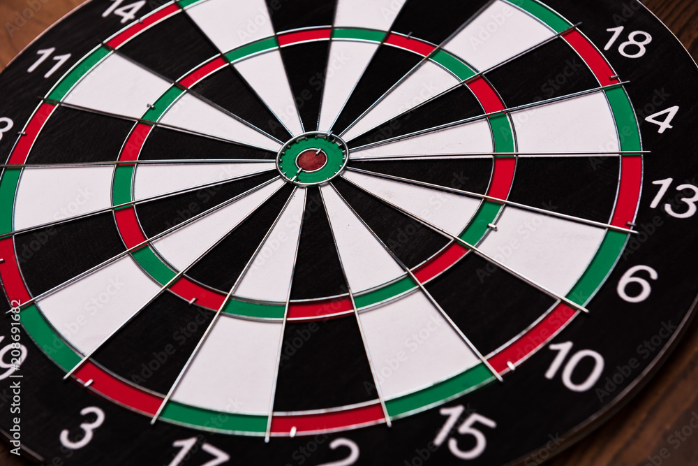 Darts board. Target on wooden table background. Darts board. Target on wooden table background.