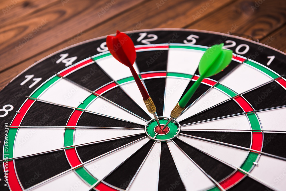 Darts hitting target. Two darts and target Darts hitting target. Two darts and target