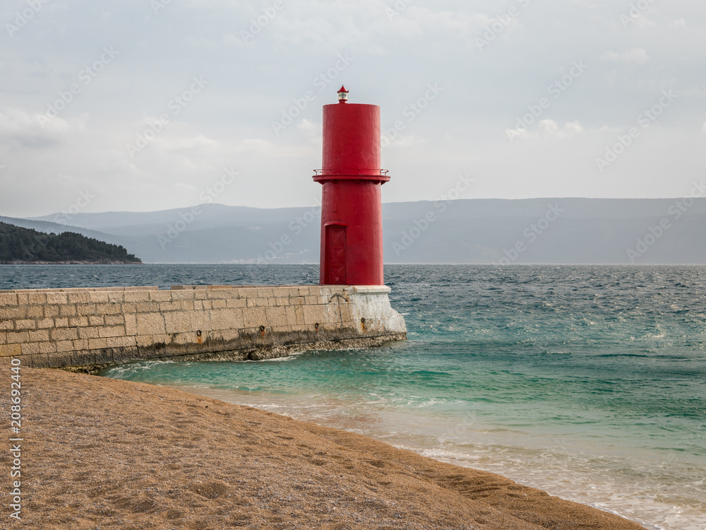 Red lighthouse of Cres on a cloudy day in spring