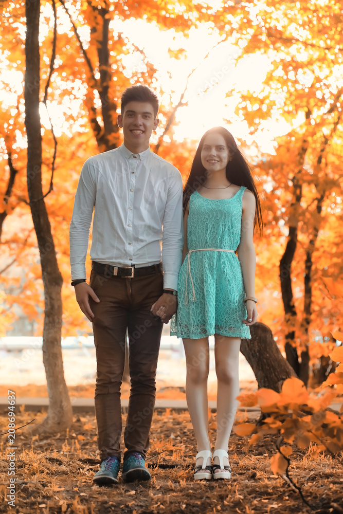 Young couple on a walk in autumn park Young couple on a walk in autumn park