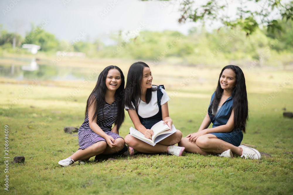 Beautiful students girls group prepare for the exam on the park Beautiful students girls group prepare for the exam on the park
