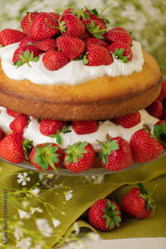 Homemade strawberry cake with cream on a glass stand. Homemade strawberry cake with cream on a glass stand.