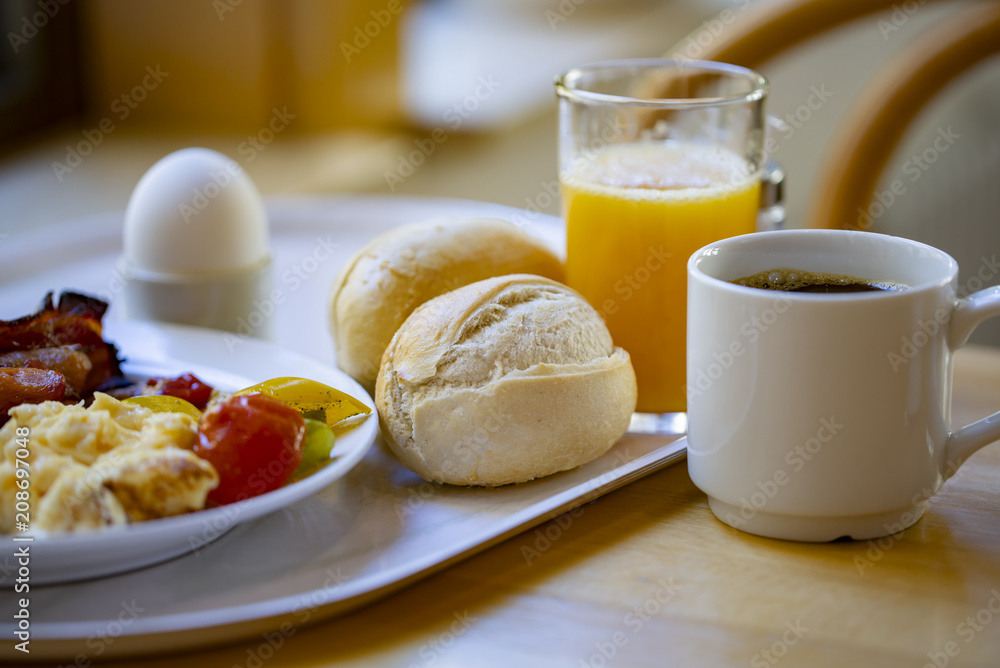 Boiled eggs ,sausages, meat ball, Bread and bacon, Orange juice, Cup of black coffee, Sliced Sweet Pepper and ham on plate, healthy breakfast. Boiled eggs ,sausages, meat ball, Bread and bacon, Orange juice, Cup of black coffee, Sliced Sweet Pepper and ham on plate, healthy breakfast.