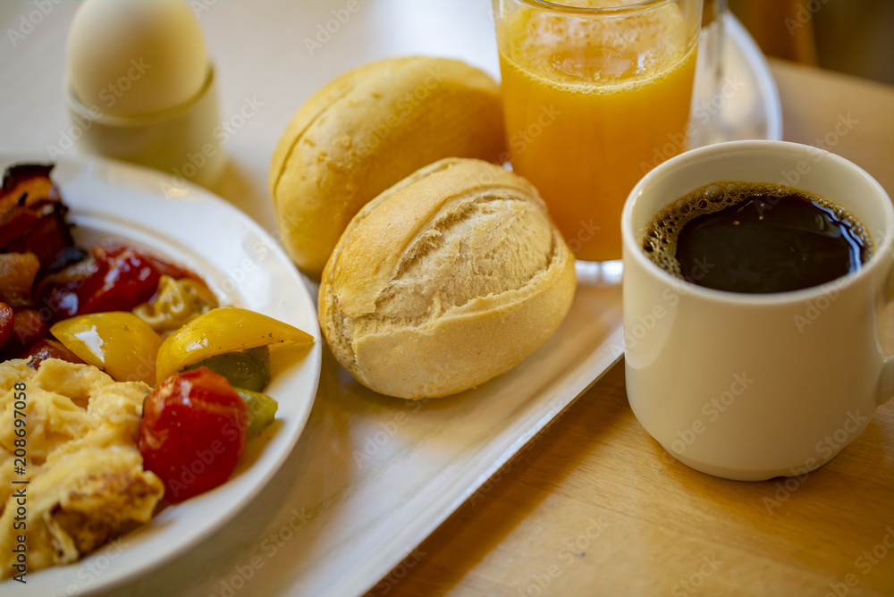 Boiled eggs ,sausages, meat ball, Bread and bacon, Orange juice, Cup of black coffee, Sliced Sweet Pepper and ham on plate, healthy breakfast. Boiled eggs ,sausages, meat ball, Bread and bacon, Orange juice, Cup of black coffee, Sliced Sweet Pepper and ham on plate, healthy breakfast.