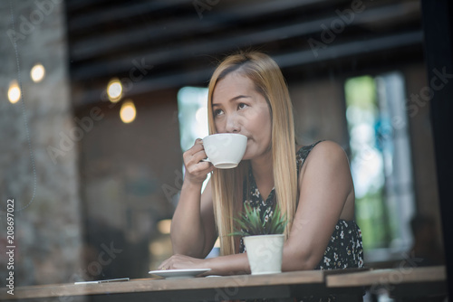 Beautiful woman in a cafe drinking coffee
