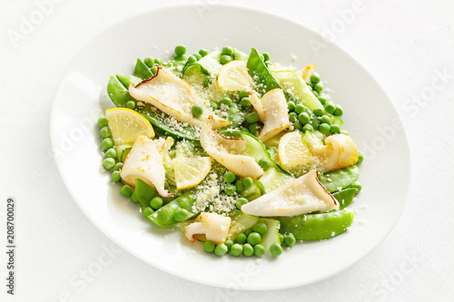 calamari pea salad with cucumber, lemon and grated cheese dressed with oil and vinegar