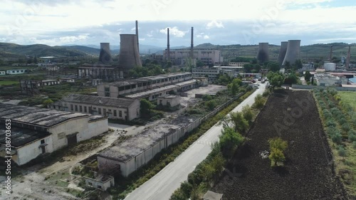 Aerial drone flight over massive abandoned Communist era industrial complex in central Albania