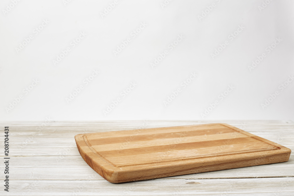 Empty bamboo cutting board on a white wooden