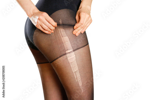 Beautiful girl in ripped black nylon pantyhose