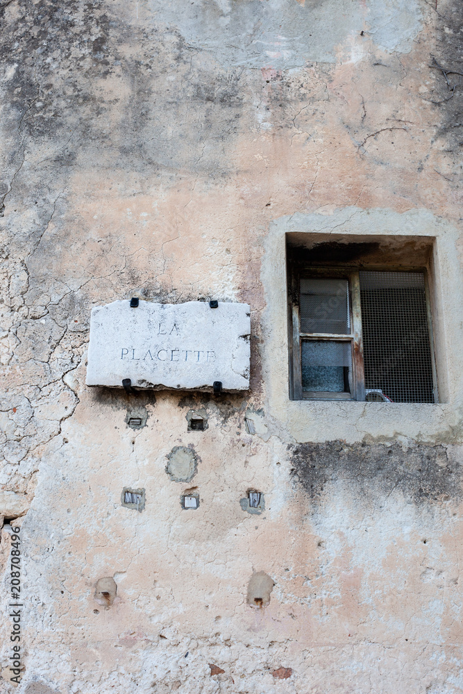 Old wall and sign in Eze, France