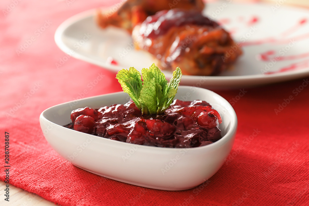 Bowl with tasty cranberry sauce on table Bowl with tasty cranberry sauce on table