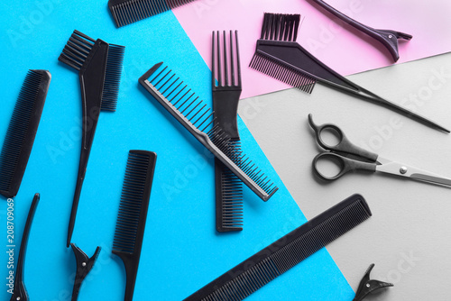 Flat lay composition with set of hairdresser's tools on color background