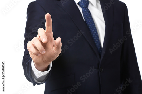 Young businessman using virtual screen on white background